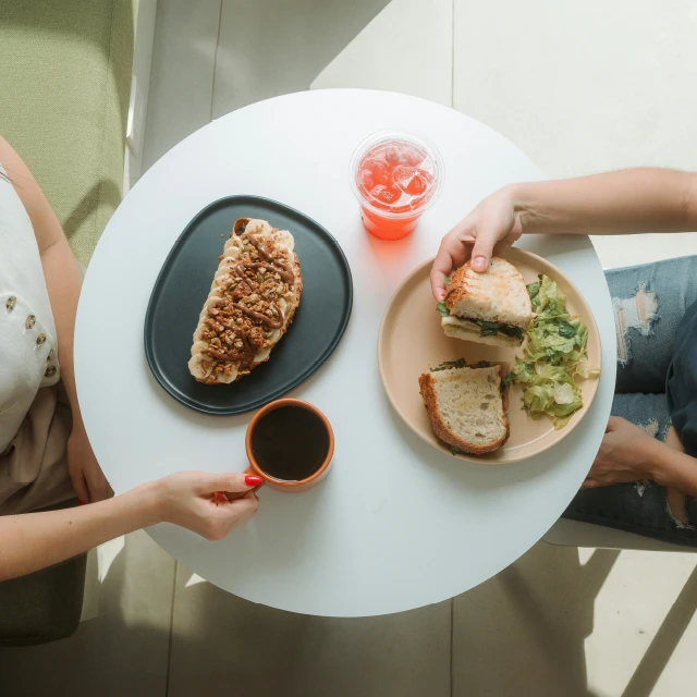 Diners eating sandwiches at a cafe